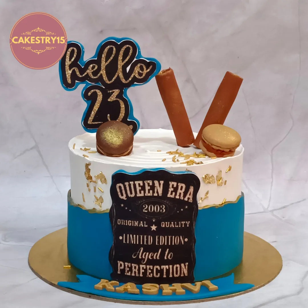 Premium eggless 23rd birthday cake for her with KitKat, fondant macarons, edible photo and pineapple flavour, handcrafted for personalised birthday celebrations in Noida.
