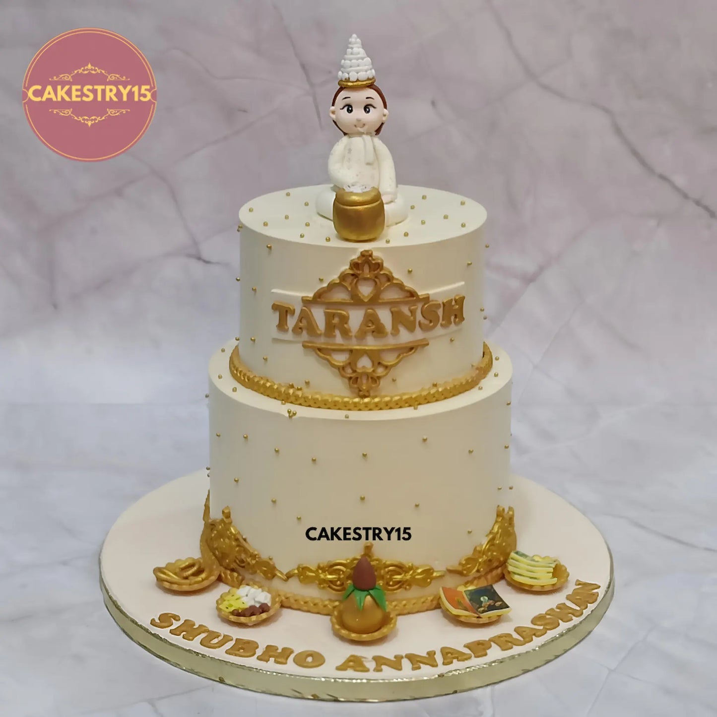 3kg choco chips Annaprashan cake with boy figurine, kalash and platters by Cakestry15 Noida.