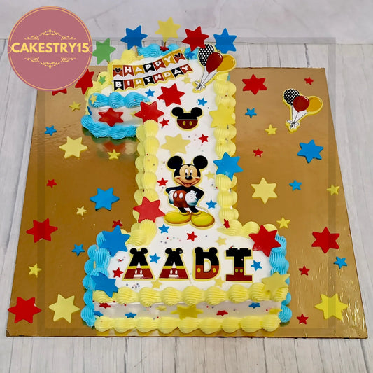 Aadi’s 2kg chocolate 1st birthday cake in digit 1 shape with Mickey Mouse edible images and fondant stars