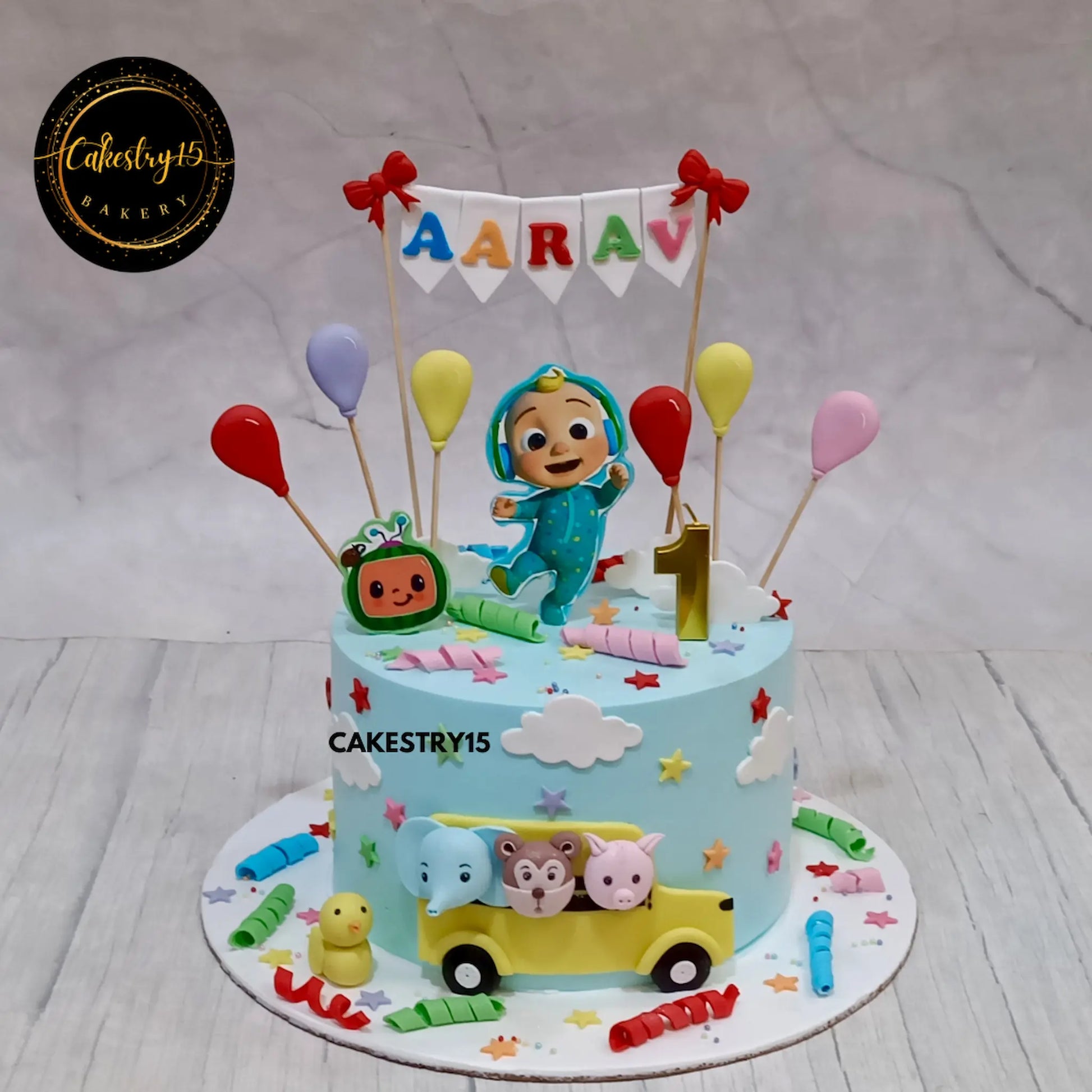 1.5kg choco vanilla Cocomelon cake with TV, bus, and fondant balloons by Cakestry15