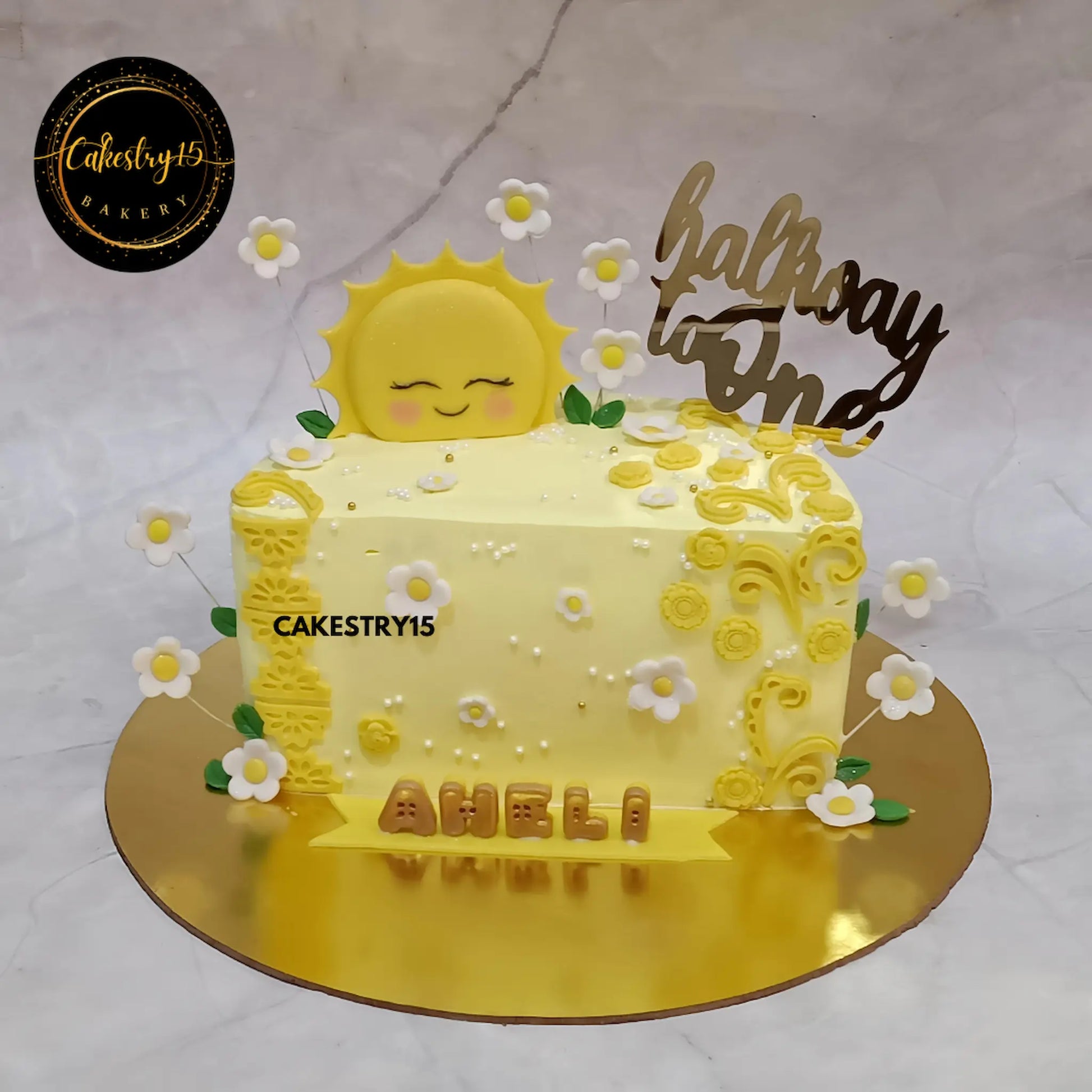 Aheli Halfway to One 1kg pineapple cake with yellow icing, fondant sun, and white-yellow flowers from Cakestry15