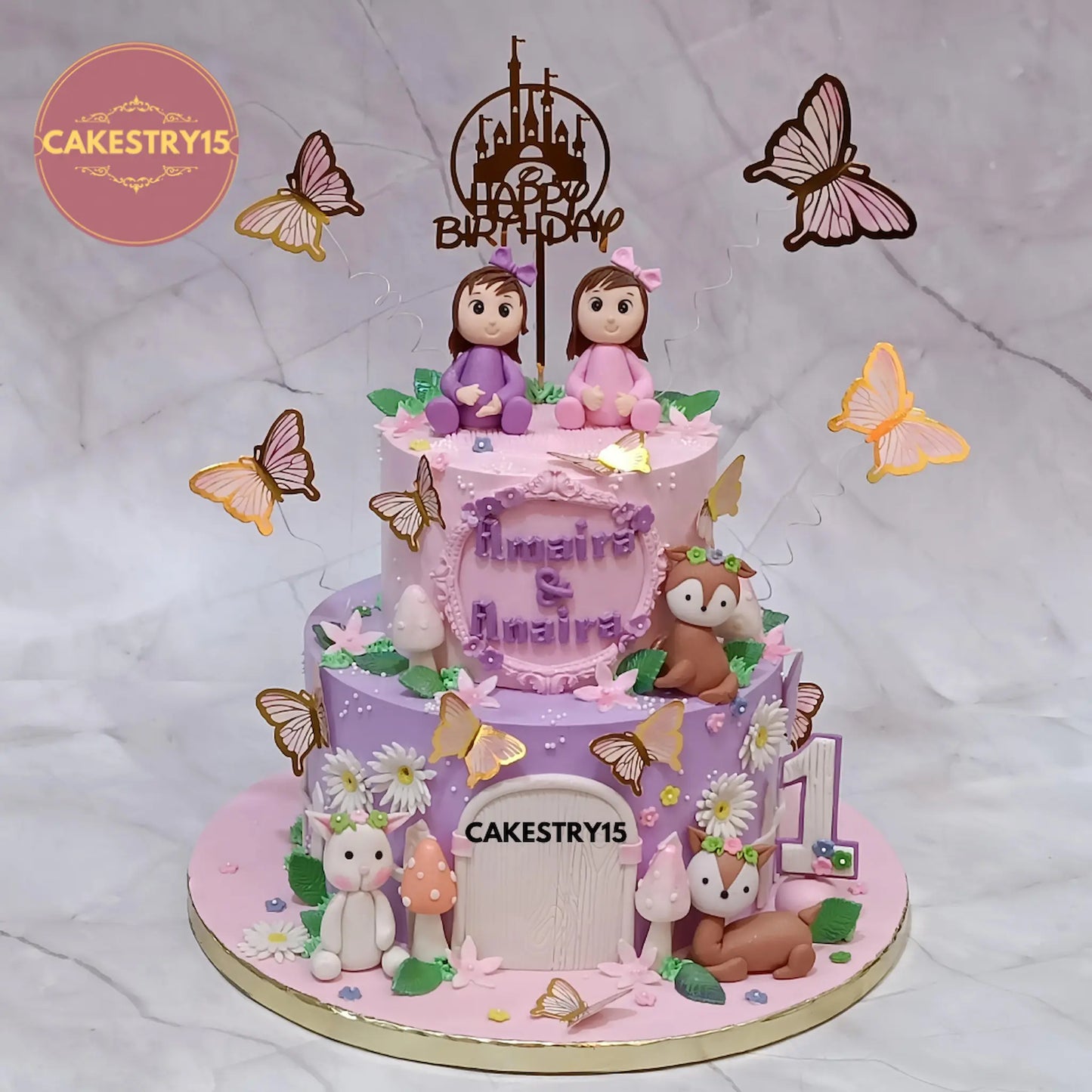 Amaira and Anaira twins’ 4kg first birthday cake in choco butterscotch flavor with forest theme decorations from Cakestry15 Noida