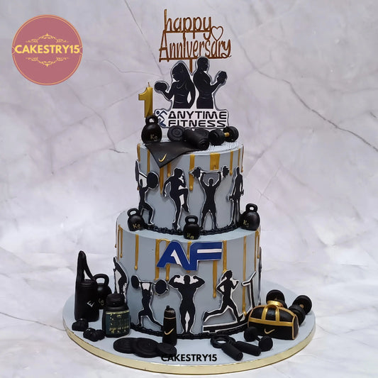 5kg chocolate gym anniversary cake with golden drip, edible workout pictures, and fondant gym equipment from Cakestry15 in noida
