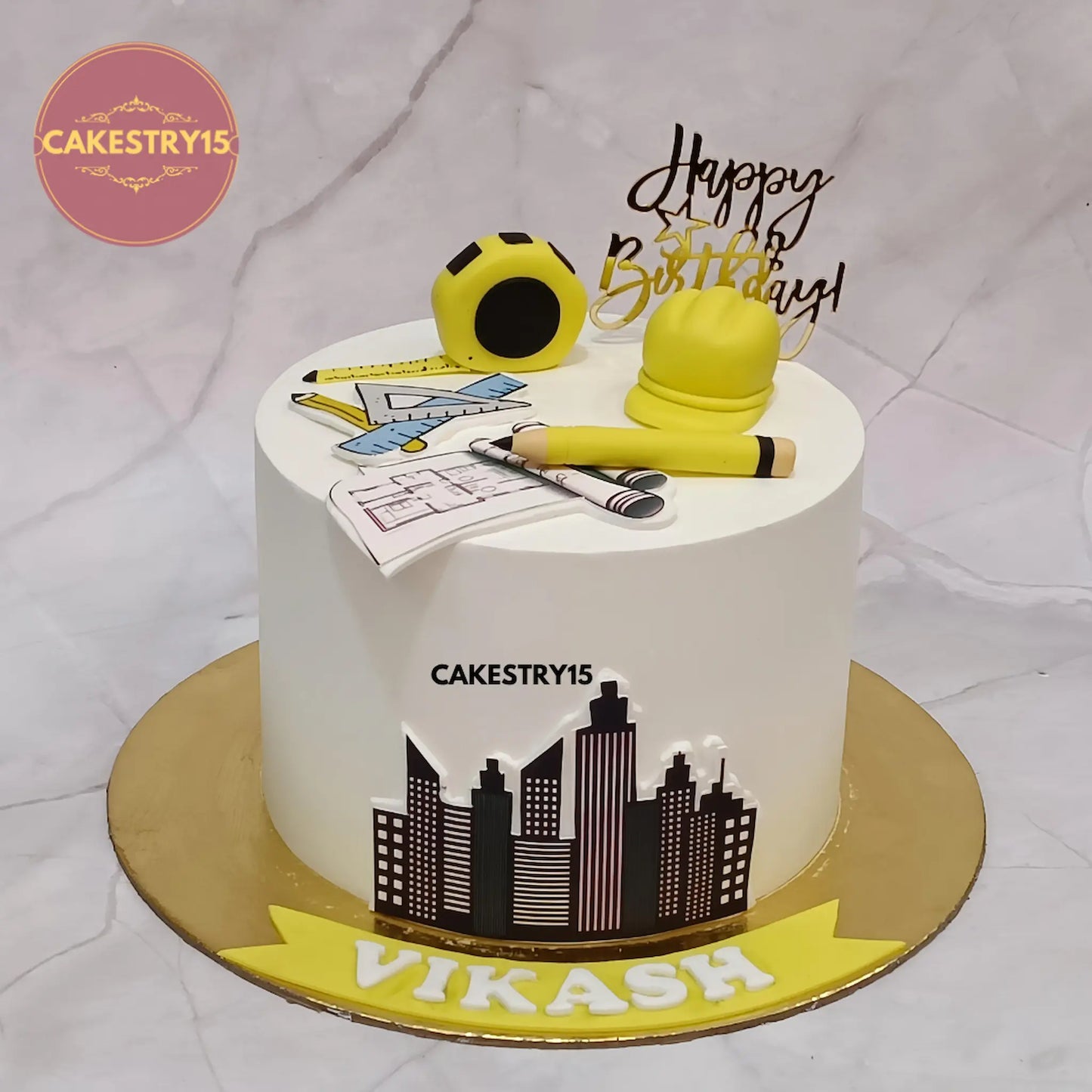 Architect theme 1kg pineapple cake with edible tools and building image from Cakestry15 Noida