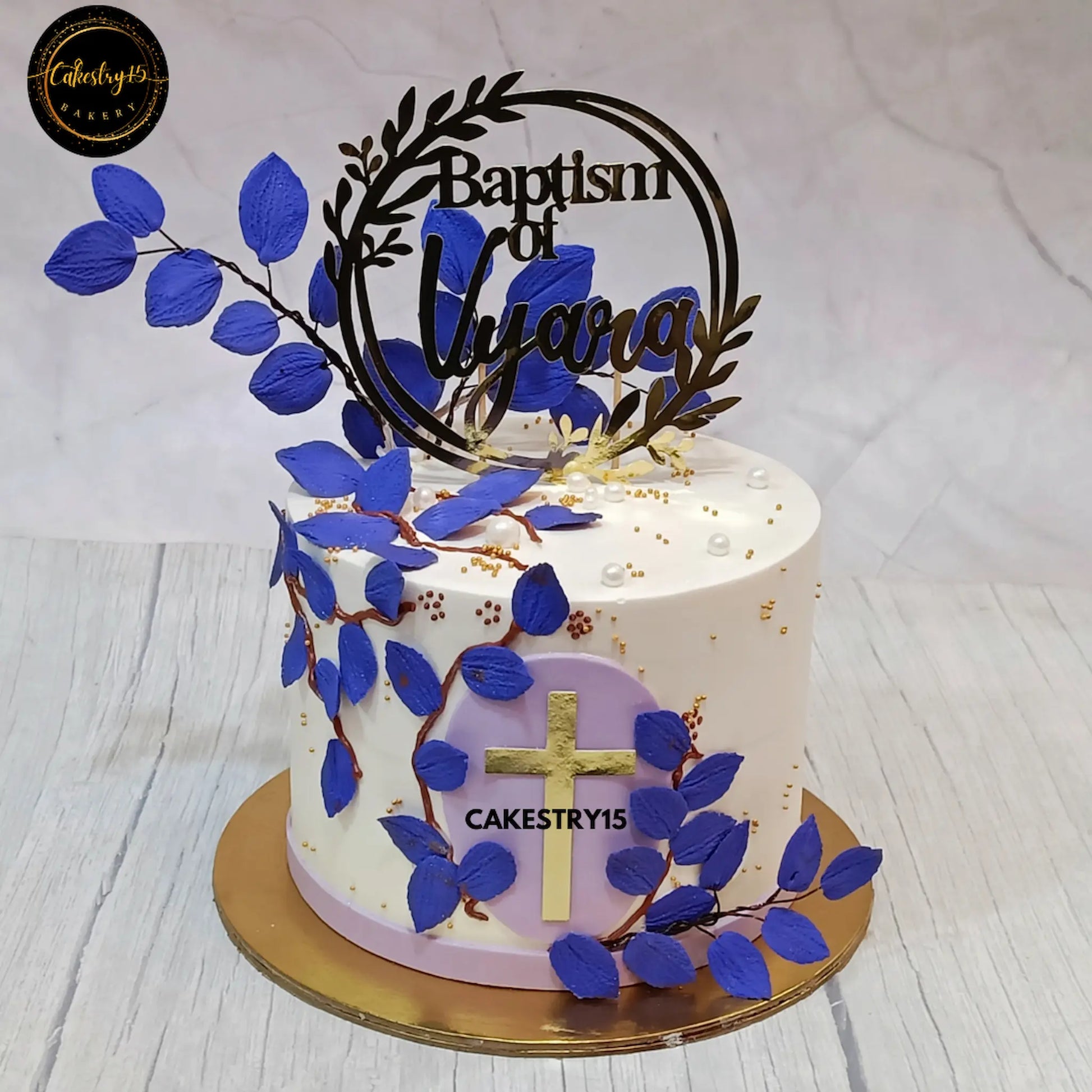 1.5kg blueberry baptism cake with custom topper and fondant blue leaves from Cakestry15