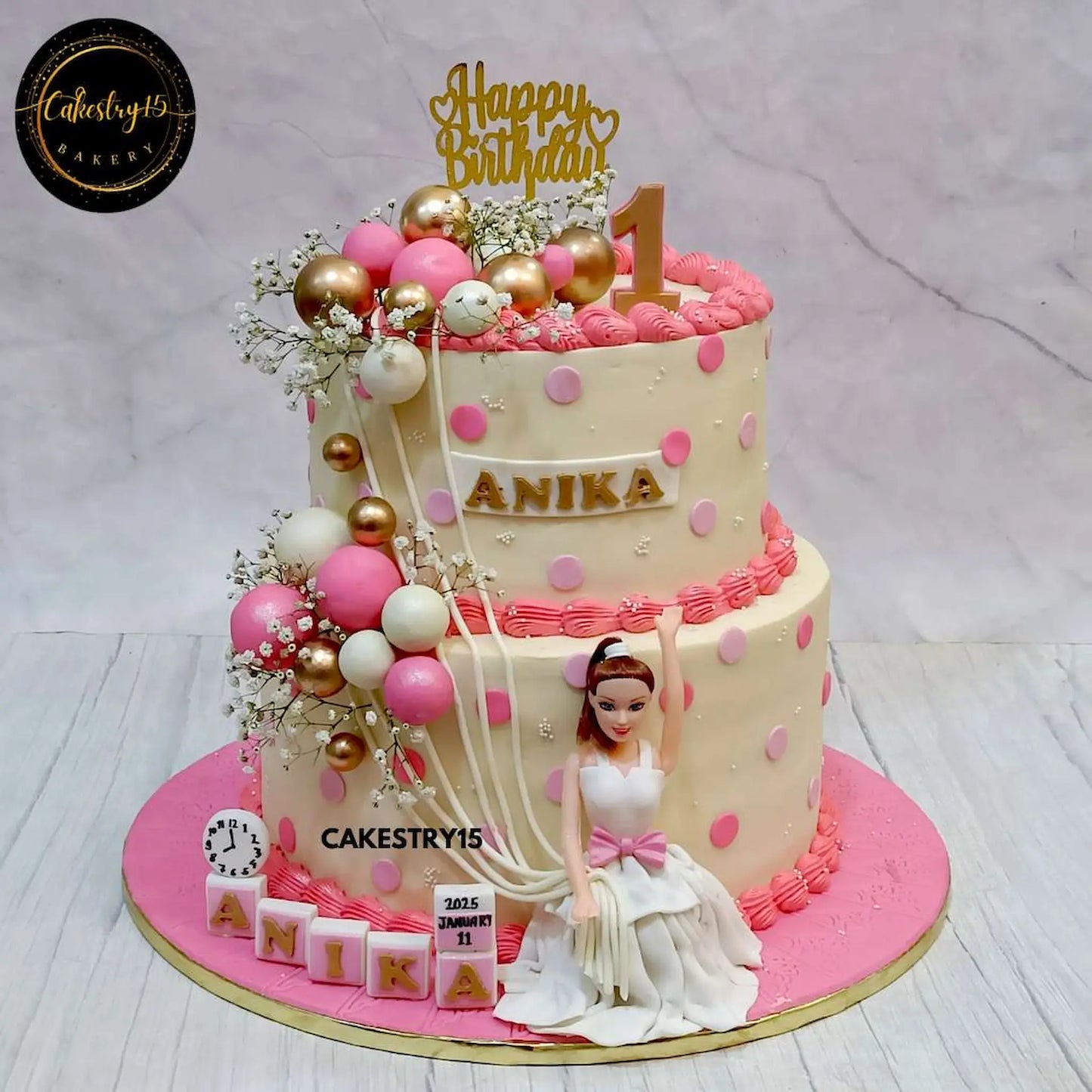 An 8kg two-tier Barbie-themed birthday cake with a Barbie doll, faux balloons, fondant blocks displaying the name, birth time clock, and a calendar by cakestry15 noida