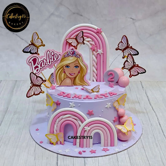 A 2kg Black Forest Barbie-themed birthday cake with an edible Barbie image, fondant rainbow, faux butterflies, and name & age tag by cakestry15 noida