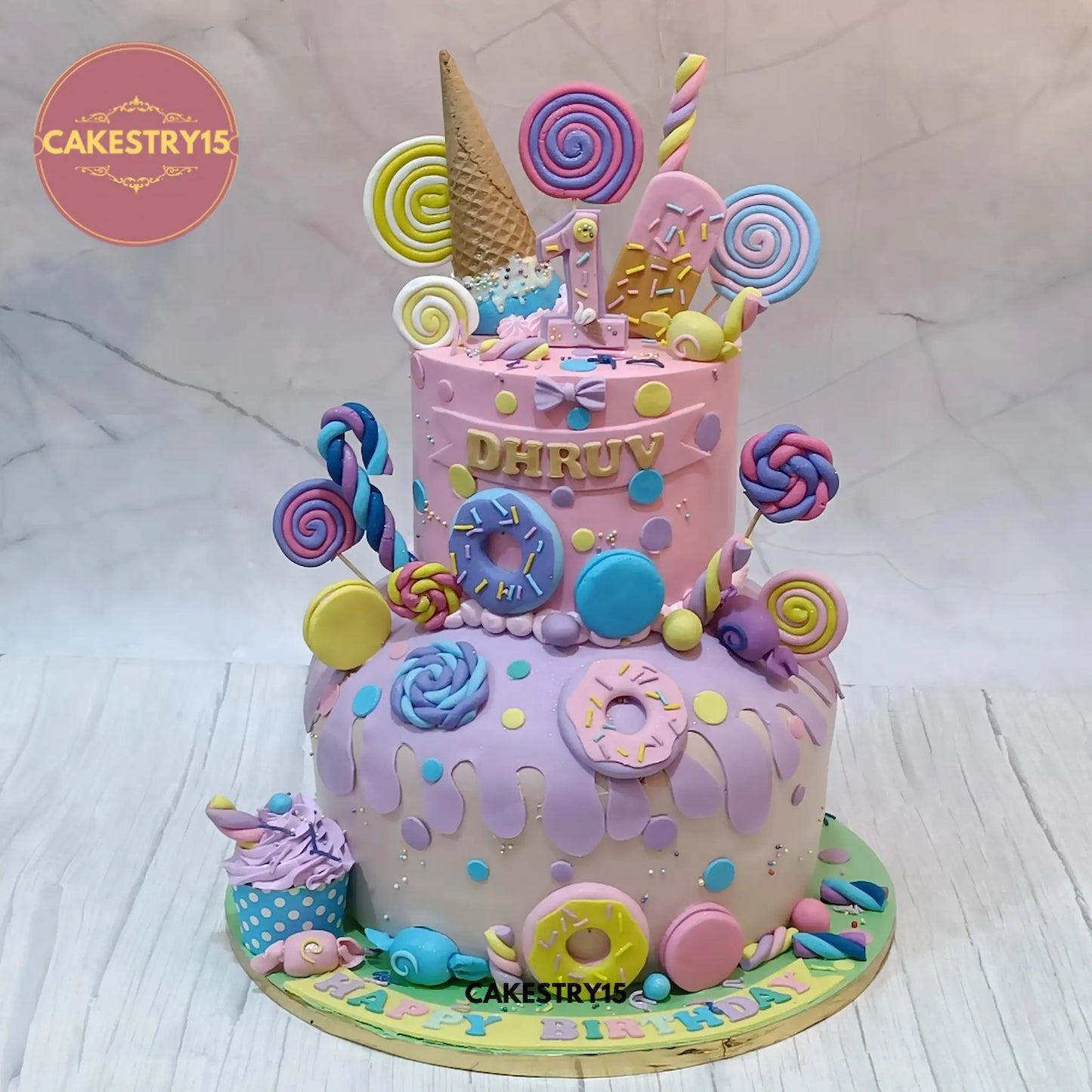 Candy Kingdom eggless first birthday cake for boys with fondant candies and choco vanilla flavour by Cakestry15 in Noida