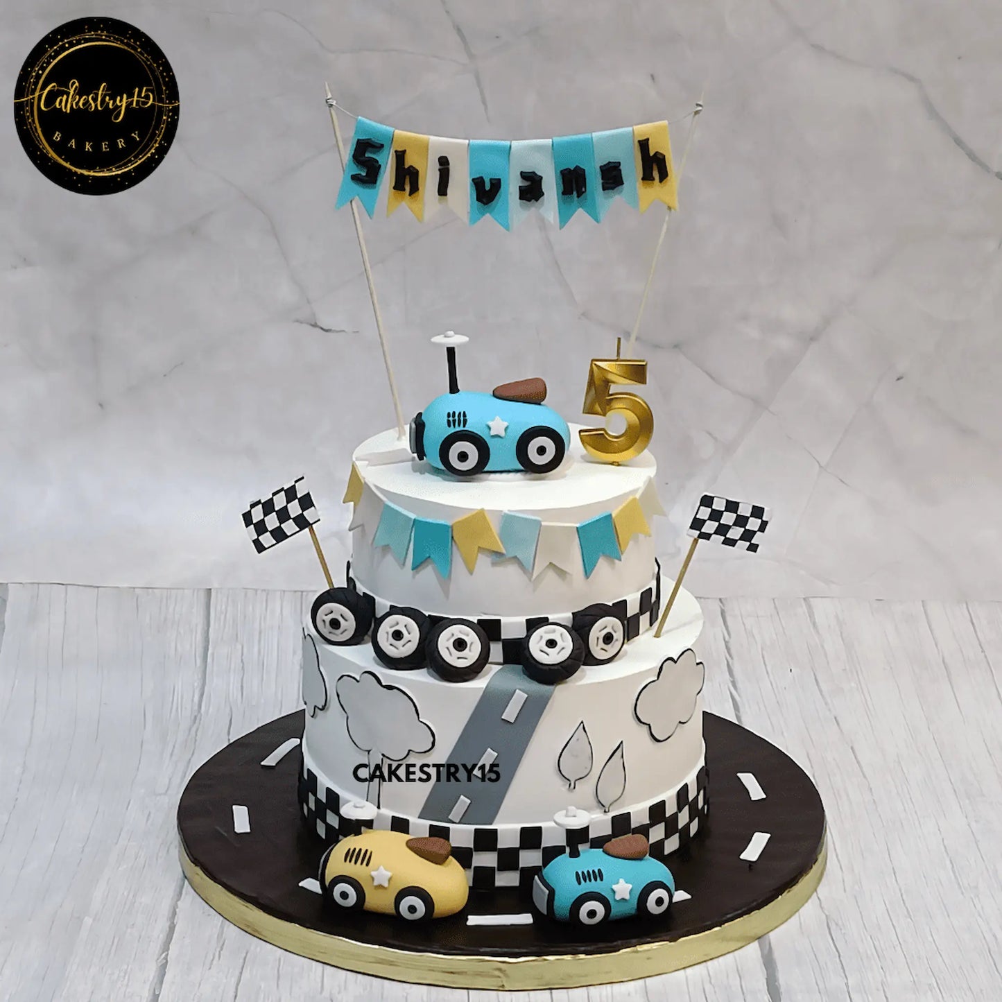 Eggless car theme kids cake with fondant racing cars and road design for Shivansh’s 5th birthday celebration in Noida