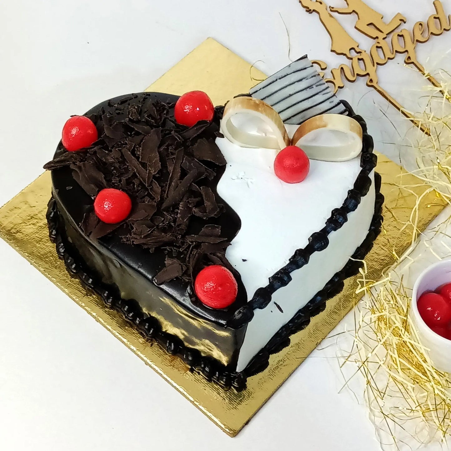 Heart-shaped 1kg black forest cake with whipped cream, strawberry compote, and chocolate toppings