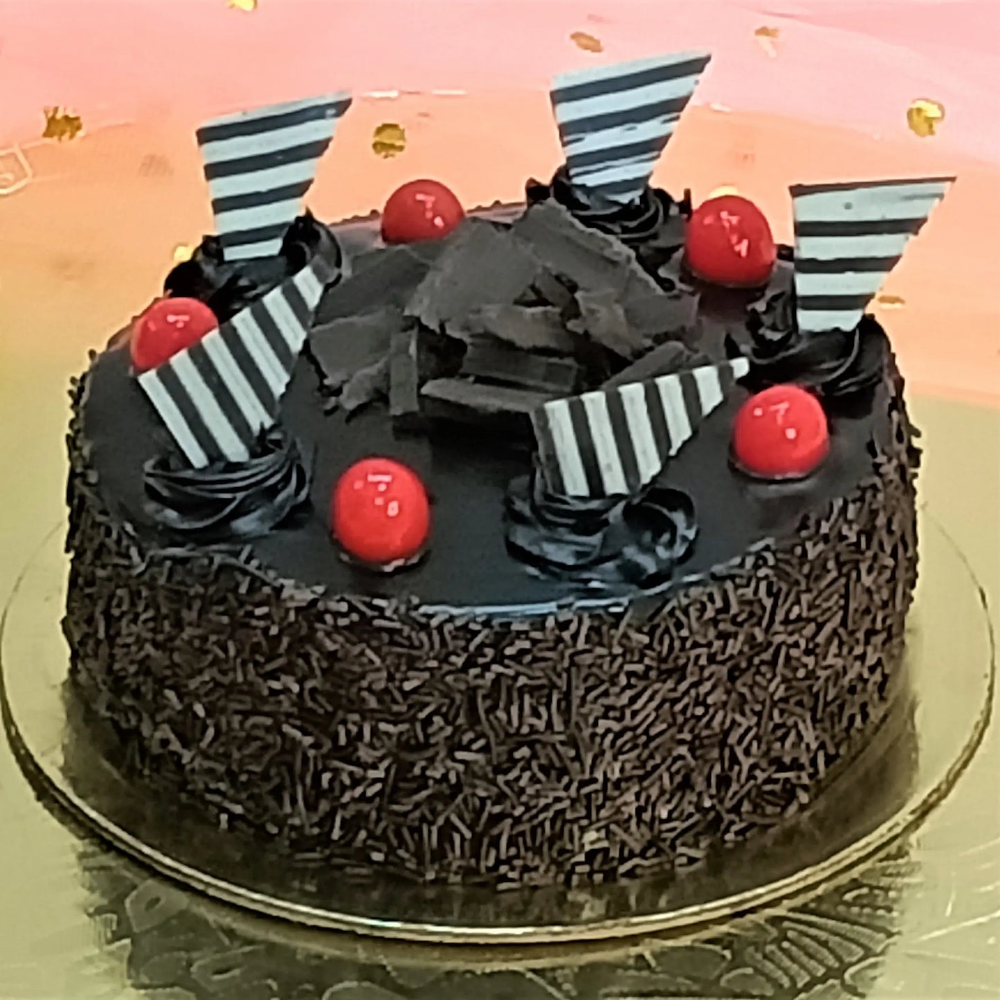 Chocolate Overload Classic Cake topped with rosettes, cherry, and chocolate accents by cakestry15 noida