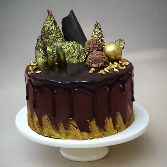 Chocolate cake with chocolate drip, Ferrero Rocher, and gold accents by cakestry15 noida