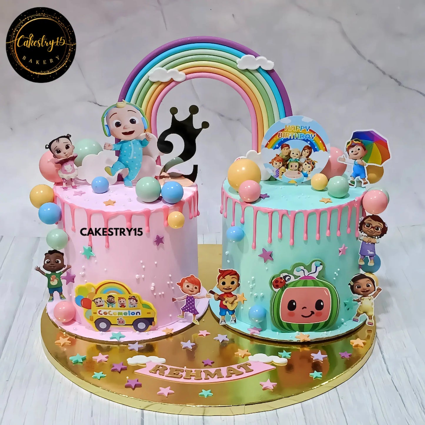 Cocomelon rainbow theme kids birthday cake in mixed fruit flavour eggless custom cake Noida for Rehmat’s 2nd birthday celebration