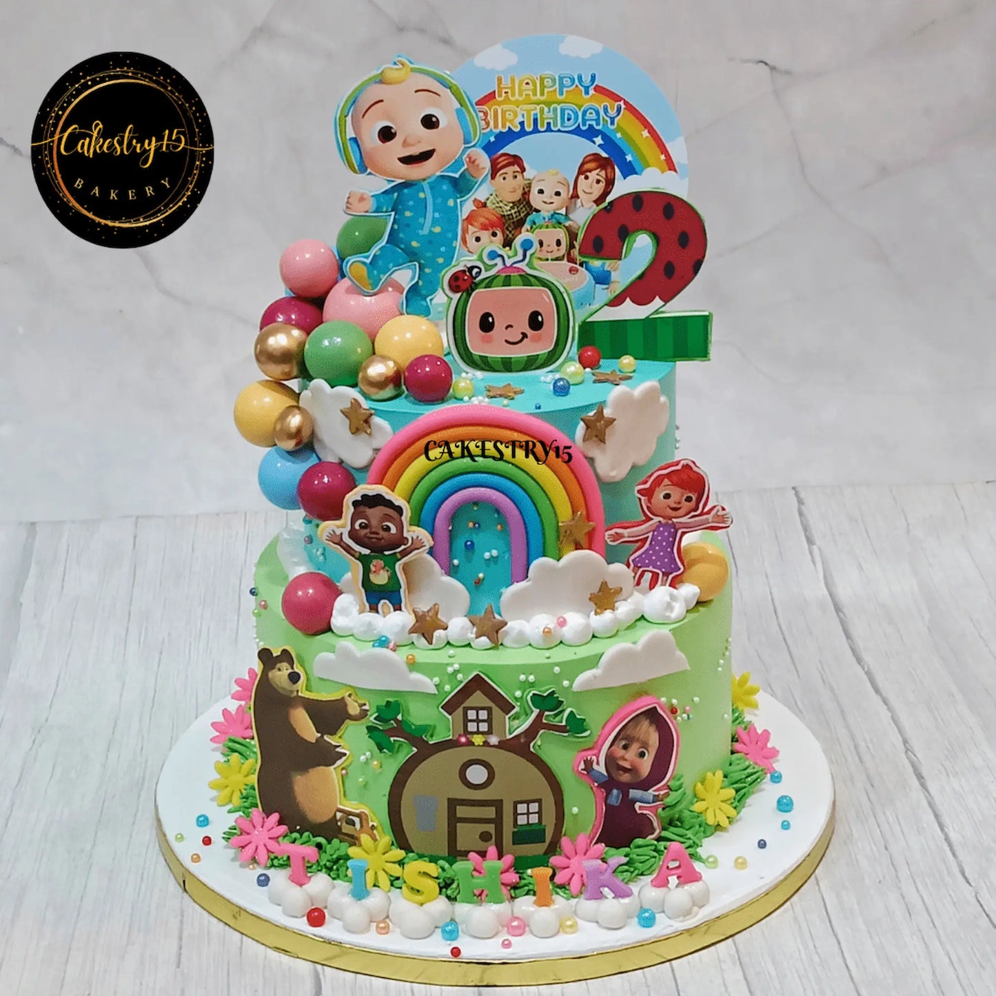 Eggless Cocomelon Masha fusion kids birthday cake in Noida with 2 tier pineapple design and colourful elements