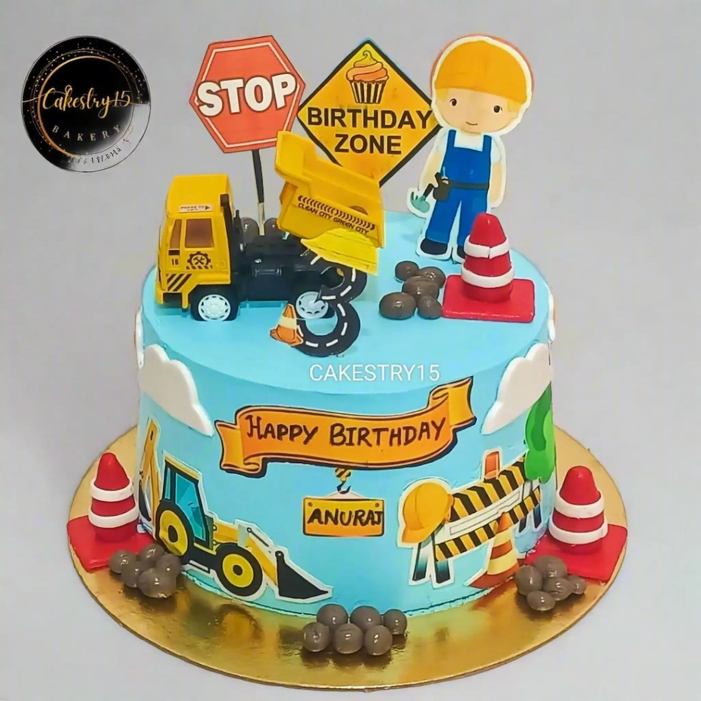 Eggless construction theme custom birthday cake for kids with JCB toy, pineapple flavour, made in Noida by Cakestry15
