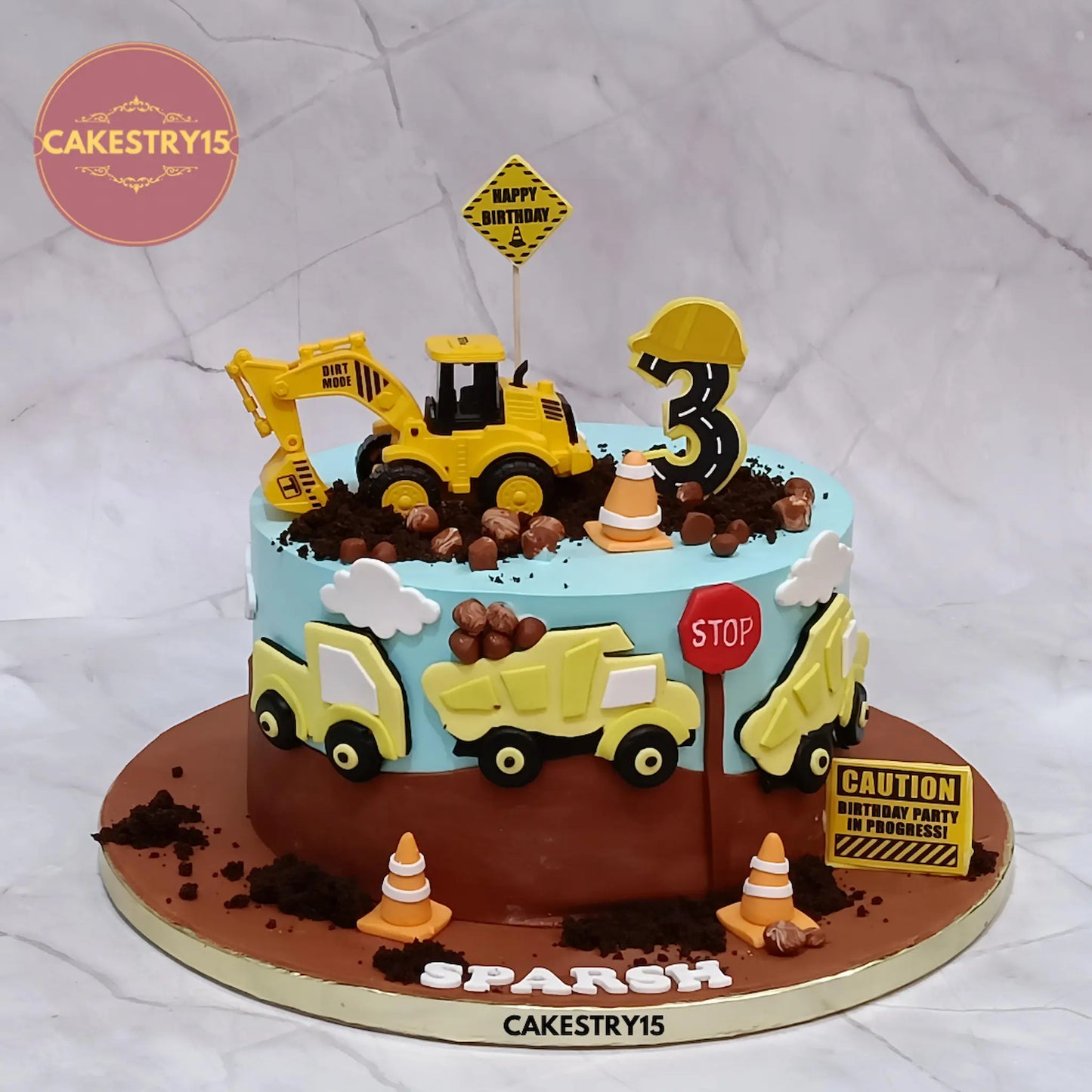 Construction theme eggless JCB birthday cake for kids with butterscotch flavour and fondant trucks in Noida