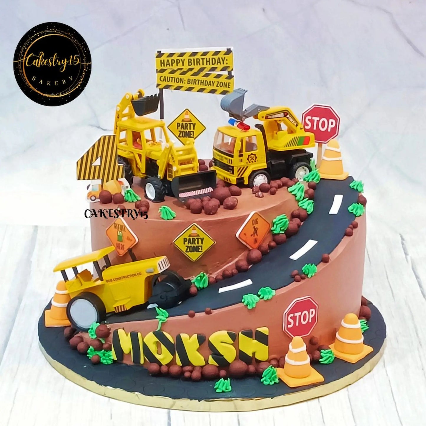 Eggless construction theme kids birthday cake with JCB toys and road design in Black Forest flavour by Cakestry15 Noida