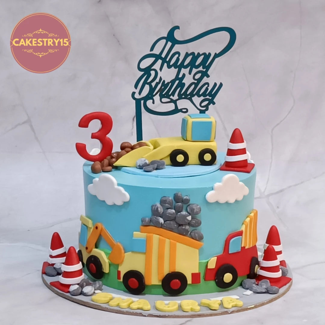 Construction zone kids birthday cake featuring a JCB and fondant trucks, crafted as premium eggless cakes and theme cake Noida celebrations.