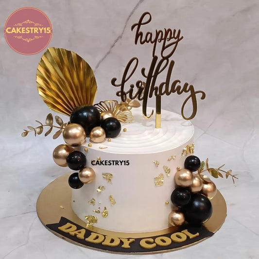1kg pineapple birthday cake for dad topped with black and gold balls, by Cakestry15 Noida