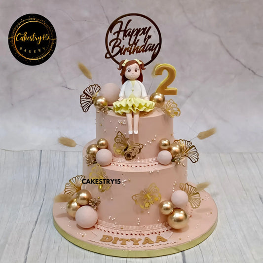 2-tier black forest cake for 2nd birthday with girl topper and golden butterflies from Cakestry15