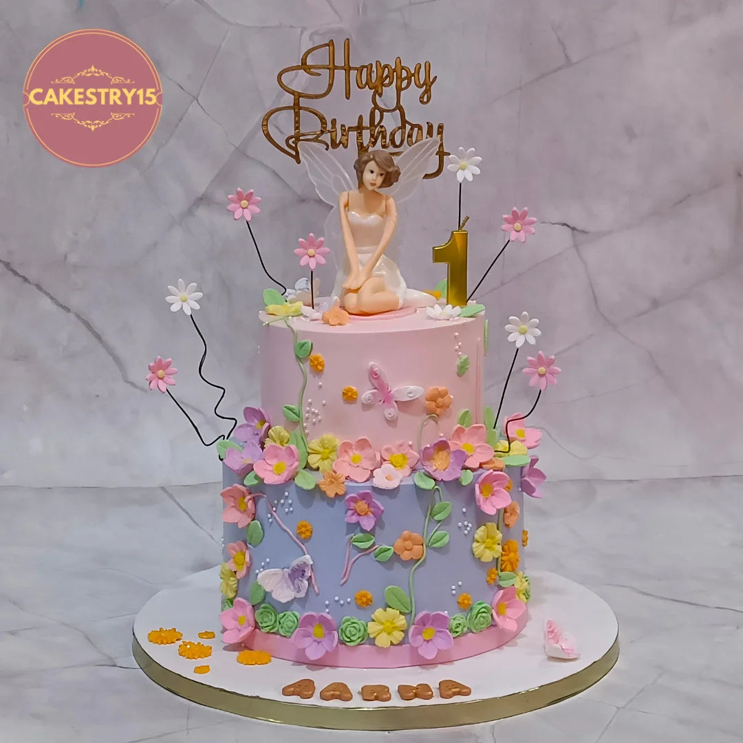 A fairy theme kids birthday cake with colourful flowers and pink lavender icing from an eggless cakes bakery offering a theme cake Noida.