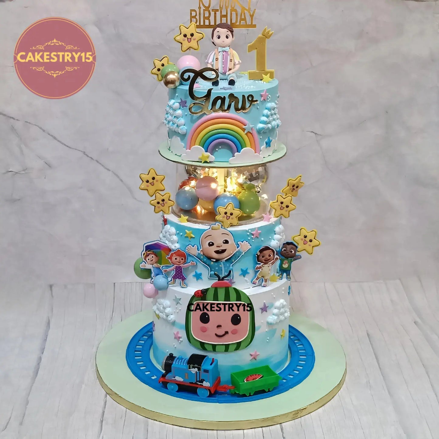 5kg 3-tier chocolate cake with toy train, fondant topper, Cocomelon theme from Cakestry15 Noida