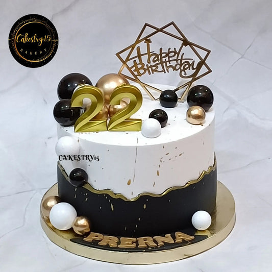1kg blueberry birthday cake with gold, white, and black faux balls and 22 candle from Cakestry15