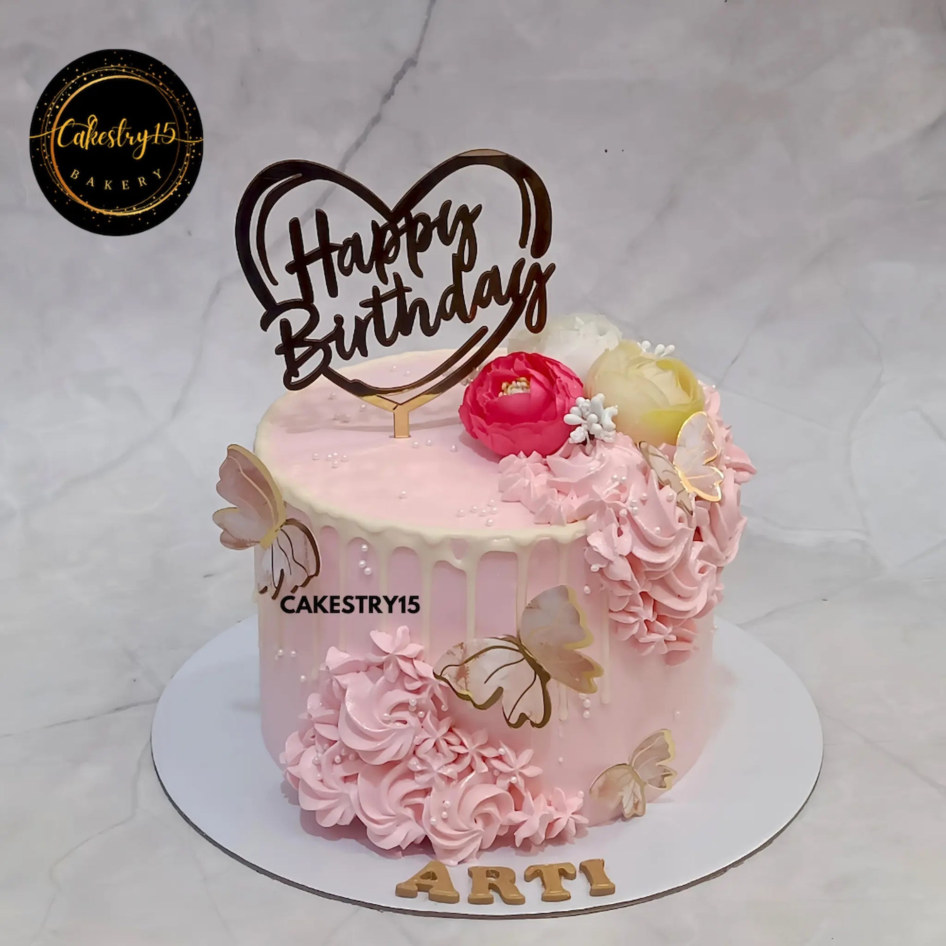 1kg eggless butterscotch birthday cake with chocolate drip and floral decor from Cakestry15