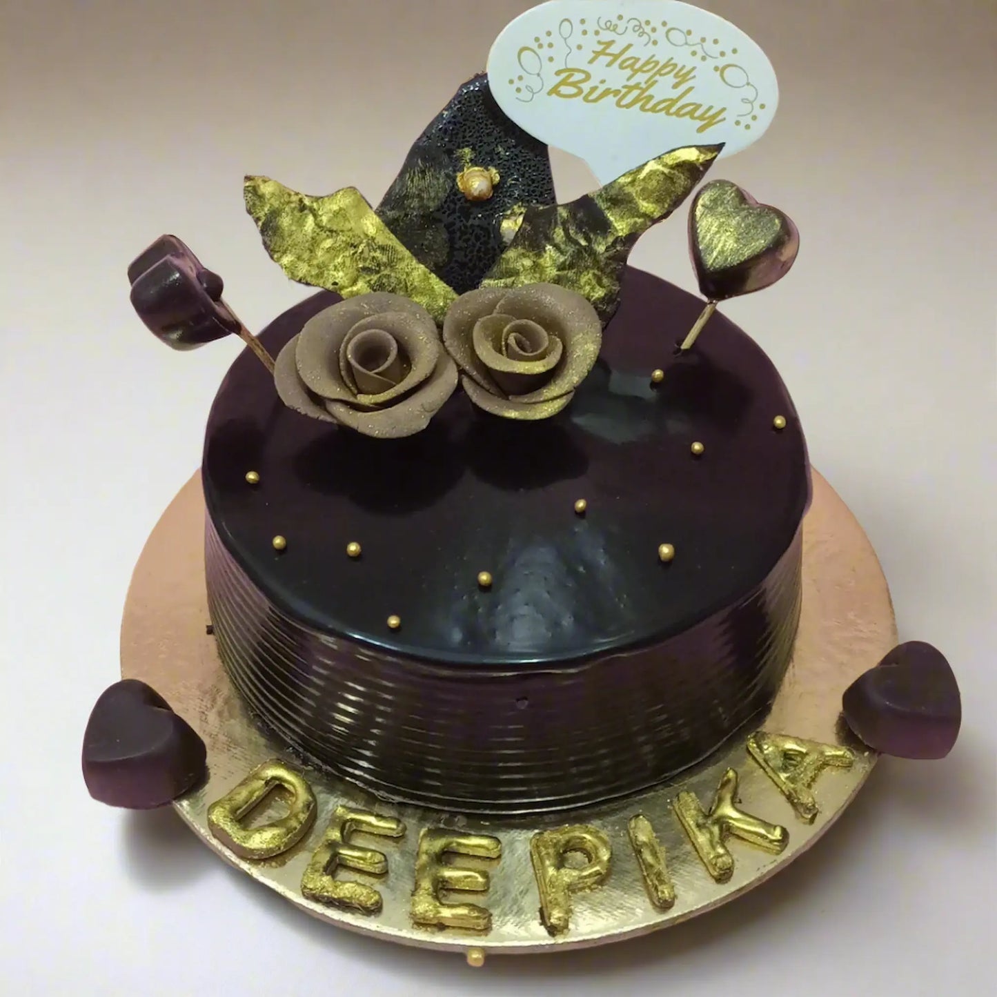 1kg chocolate birthday cake for Deepika with gold roses and hearts by cakestry15 noida