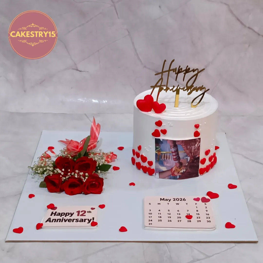 Premium eggless happy 12th anniversary cake with edible couple image, fondant hearts, rose bouquet and personalised calendar, handcrafted in Noida.