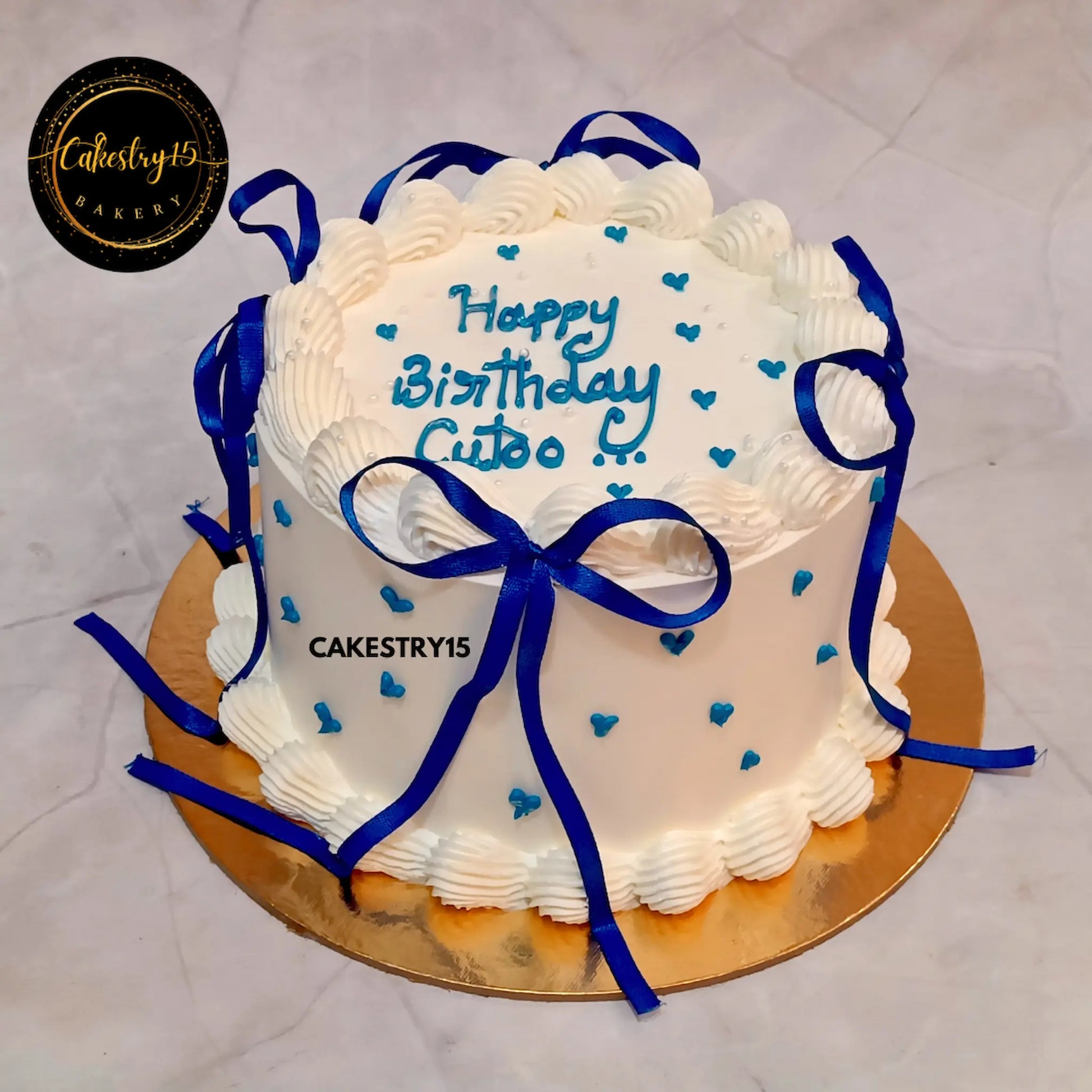 1kg pineapple eggless cake with blue hearts and ribbons from Cakestry15