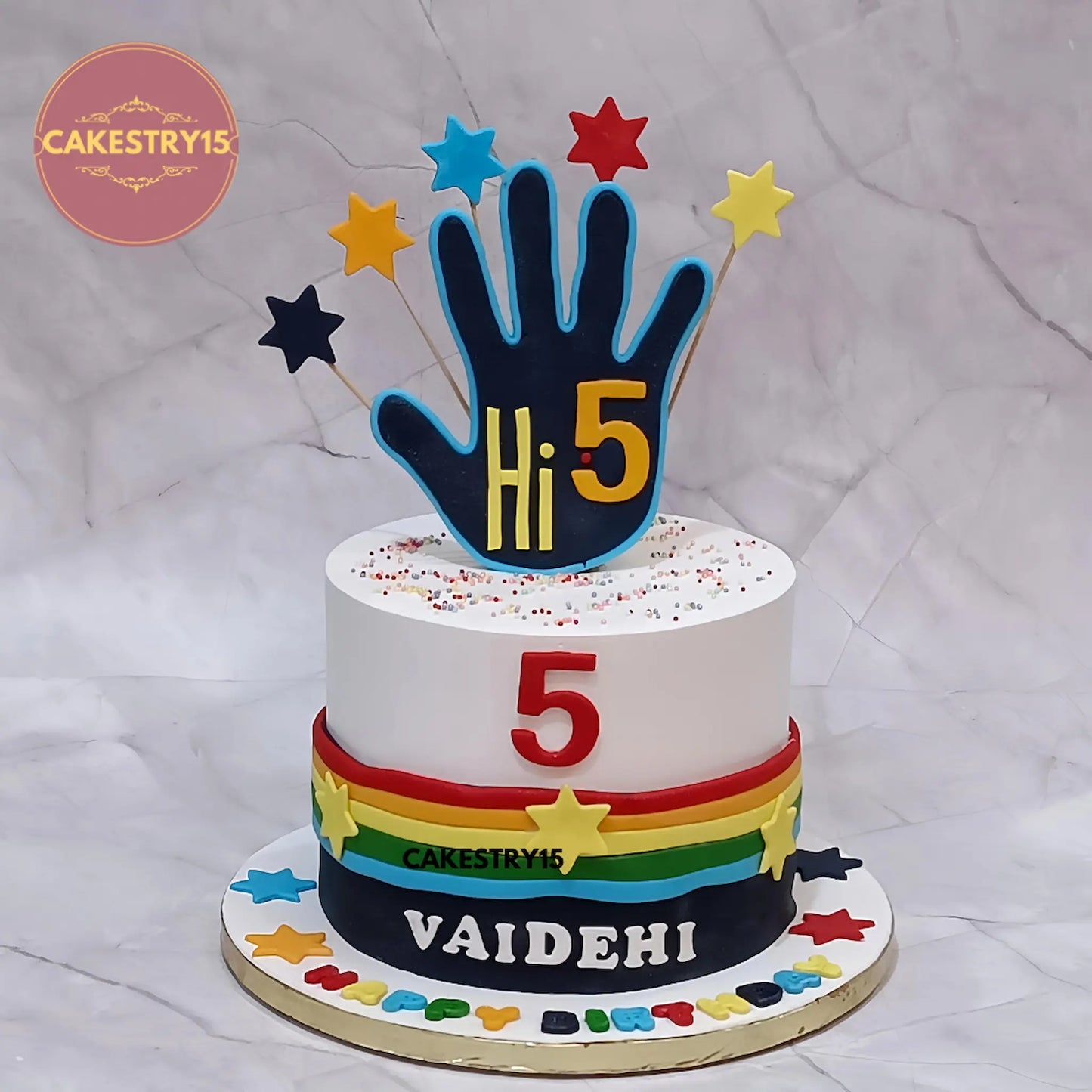Eggless Hi5 kids birthday cake with colourful fondant strips and stars, premium theme cake Noida for birthday celebrations.