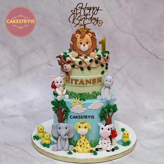 Hitansh jungle theme 3kg choco butterscotch first birthday cake with lion, giraffe, elephant, zebra, pig, cat, and ducklings by cakestry15 in noida