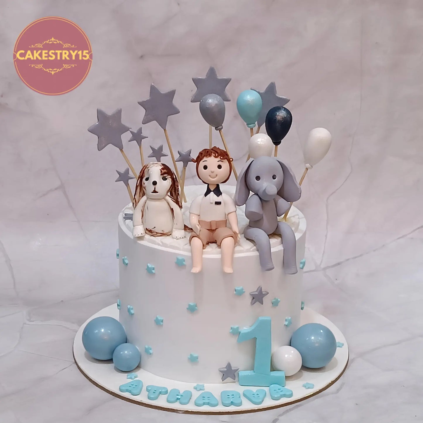 Eggless jungle theme kids birthday cake in pineapple flavour with fondant figurines and balloons, premium theme cake Noida for first birthday celebrations.