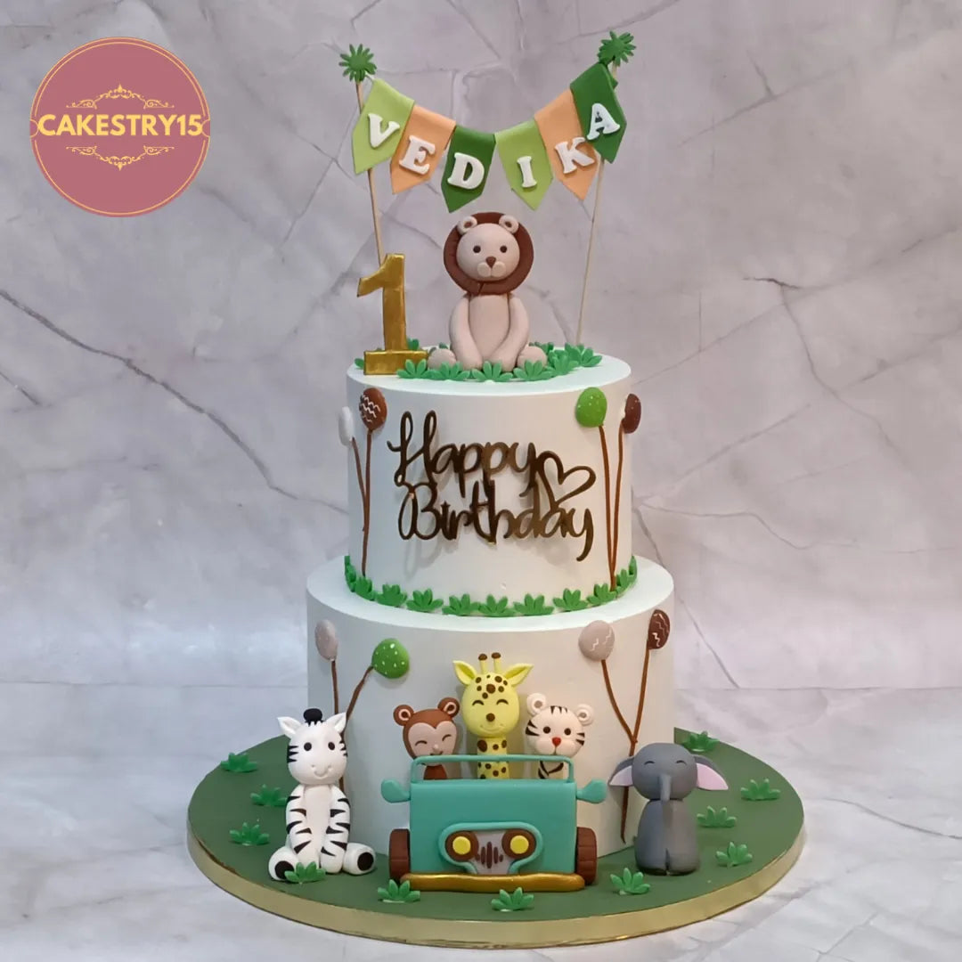 Eggless jungle theme kids birthday cake with fondant safari animals for first birthday celebrations in Noida.