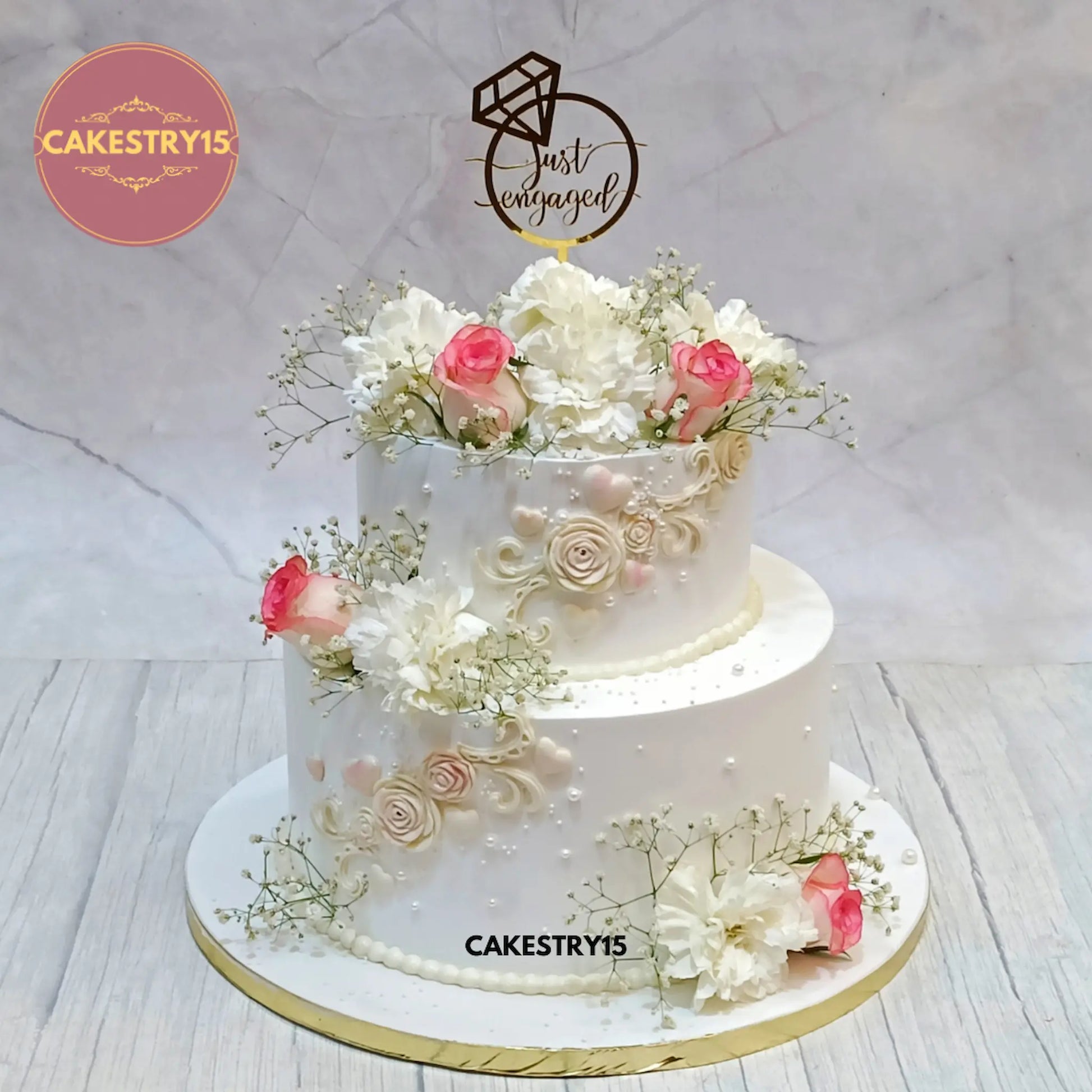 5kg chocolate engagement cake with baby breath, carnations, and fondant roses from Cakestry15 in noida