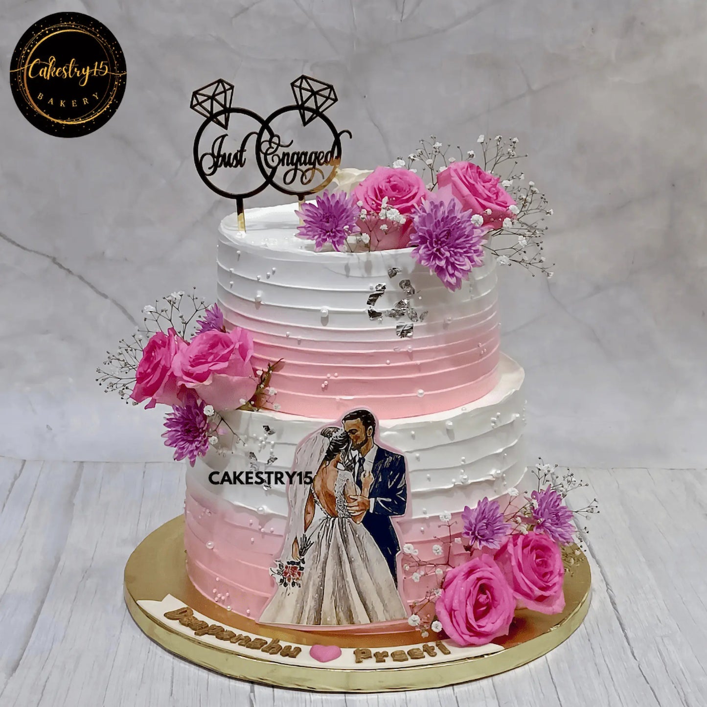 5kg two-tier engagement cake with Black Forest and Blueberry flavors, pink roses, carnations, and personalized topper by cakestry15,best bakery noida,cake for couples