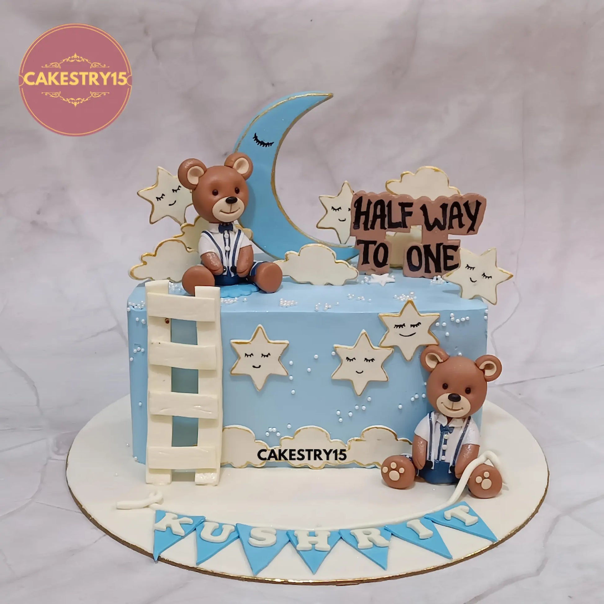 1kg pineapple half-birthday cake with teddies, moon, stars, and name on base from Cakestry15 in noida