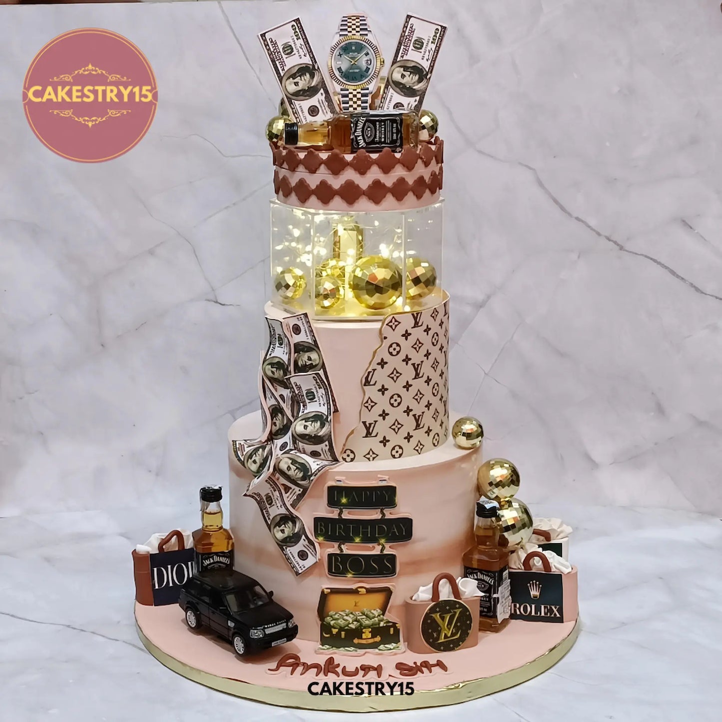 5kg luxury boss chocolate birthday cake with Louis Vuitton, dollar bills, Jack Daniel’s bottles, and rotating LED display from Cakestry15 Noida