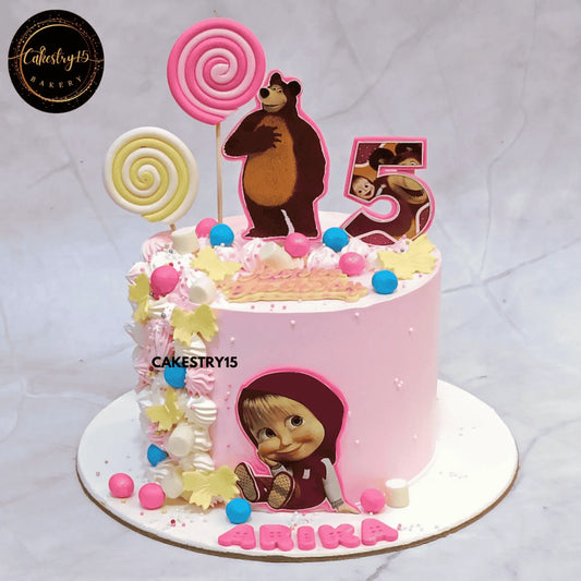 1kg butterscotch Masha and the Bear theme cake for Arika’s 5th birthday with candy swirls and edible character images by cakestry15,best bakery noida