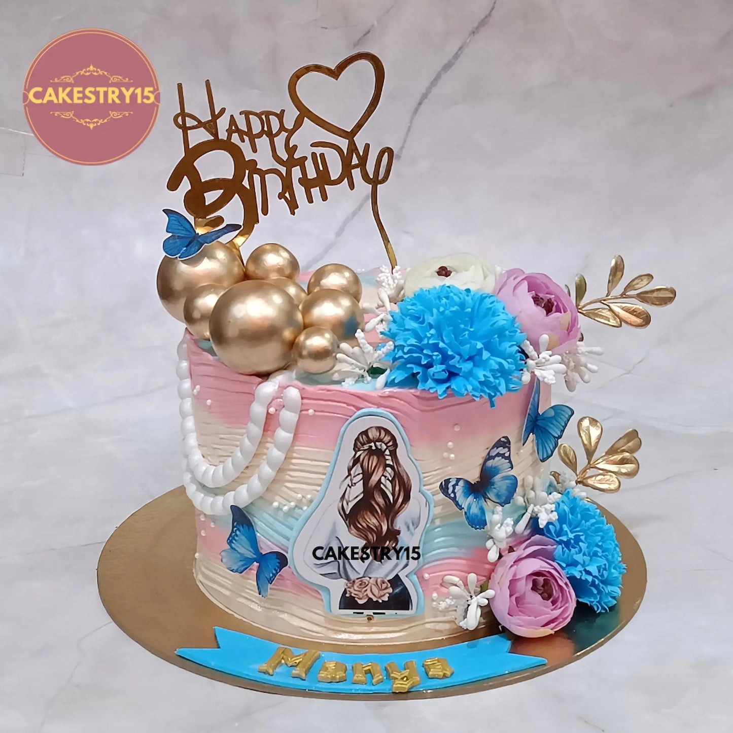 1kg butterscotch farewell cake with golden balls, roses, carnations, ferns, baby breath and butterflies from Cakestry15 Noida