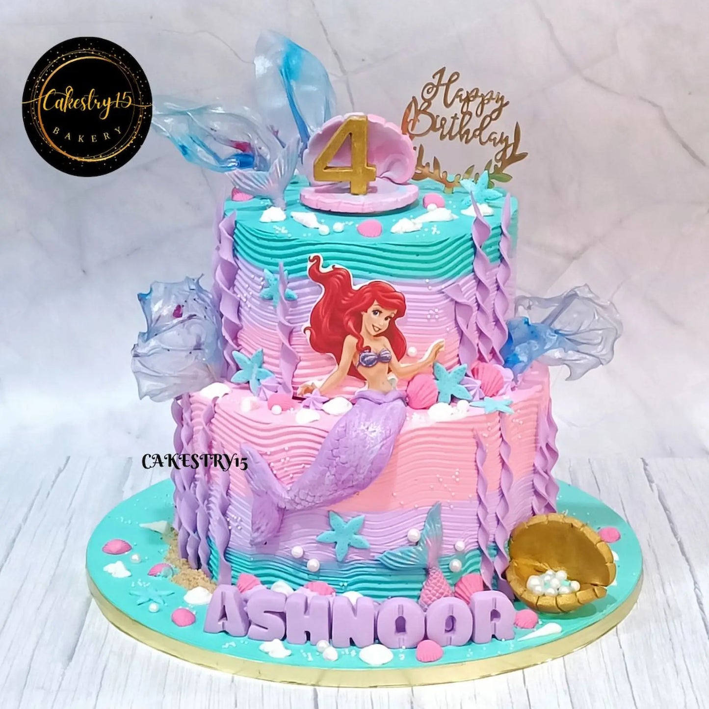 Mermaid swirls kids birthday cake with ocean details from an eggless cakes bakery offering a theme cake Noida.