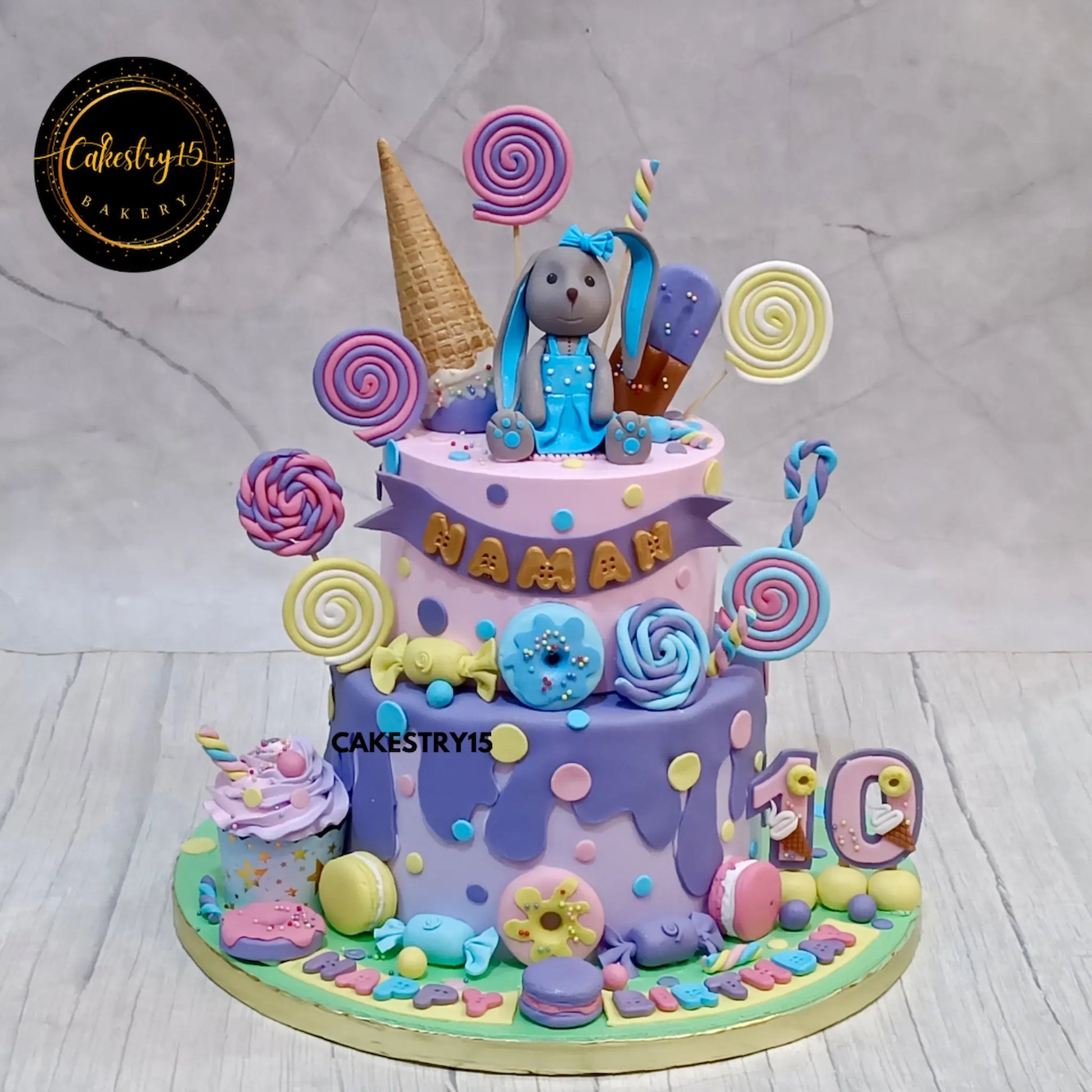 2-tier choco vanilla Candyland theme cake for Naman’s 10th birthday featuring rabbit topper and fondant sweets