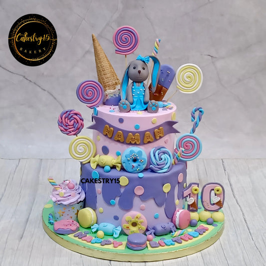 2-tier choco vanilla Candyland theme cake for Naman’s 10th birthday featuring rabbit topper and fondant sweets