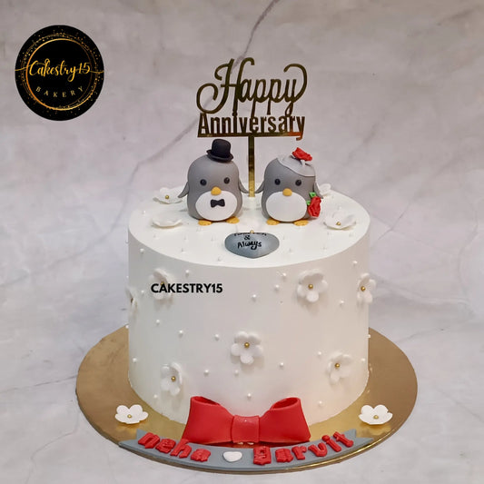 1kg pineapple anniversary cake with penguins, pearls, white flowers, and bow from Cakestry15