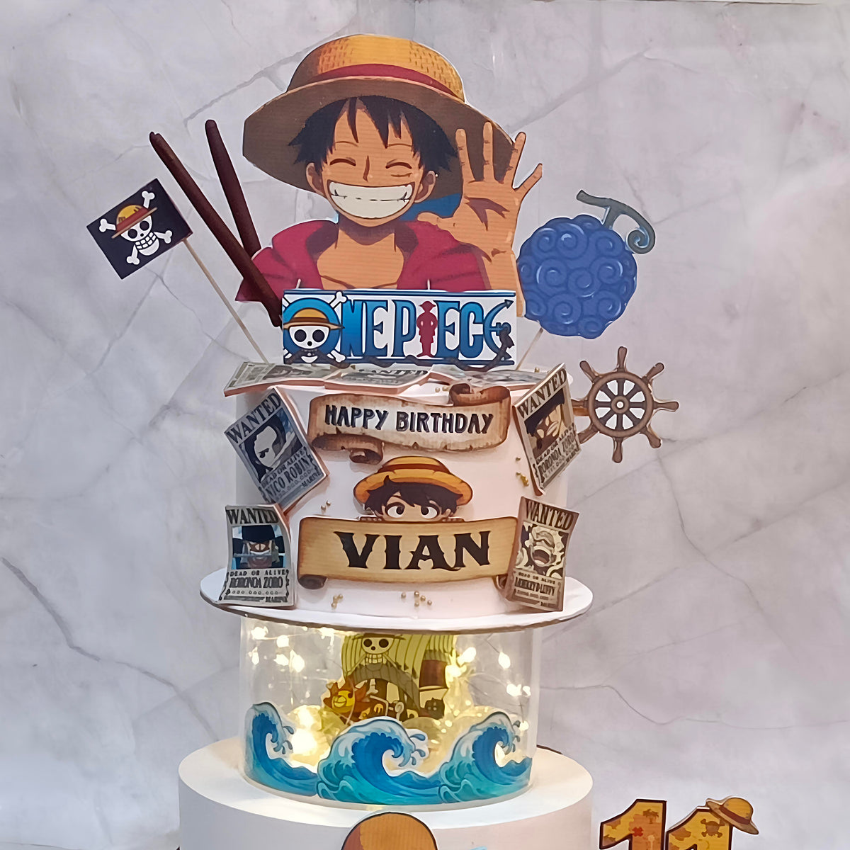 Close-up of One Piece anime theme cake top tier with Luffy details, created as a kids birthday cake in Noida