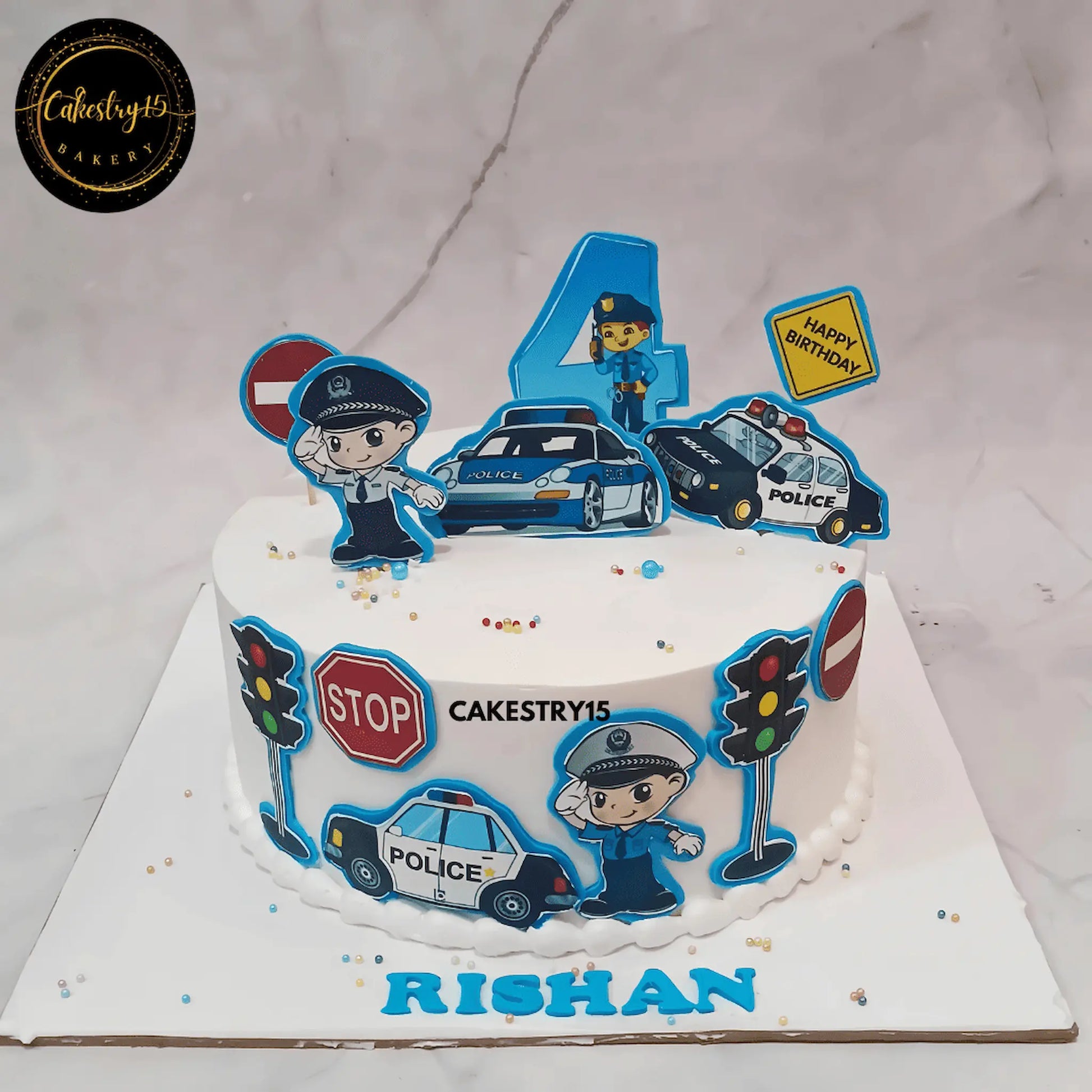 Police-themed black forest birthday cake for a 4-year-old with edible images of policemen, police cars, traffic signals, and stop signs by cakestry15 noida