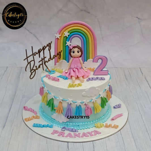 1.5kg Black Forest birthday cake for a 2-year-old, featuring a girl figurine, a rainbow, confetti, and a birthday tag by cakestry15 noida, best bakery noida
