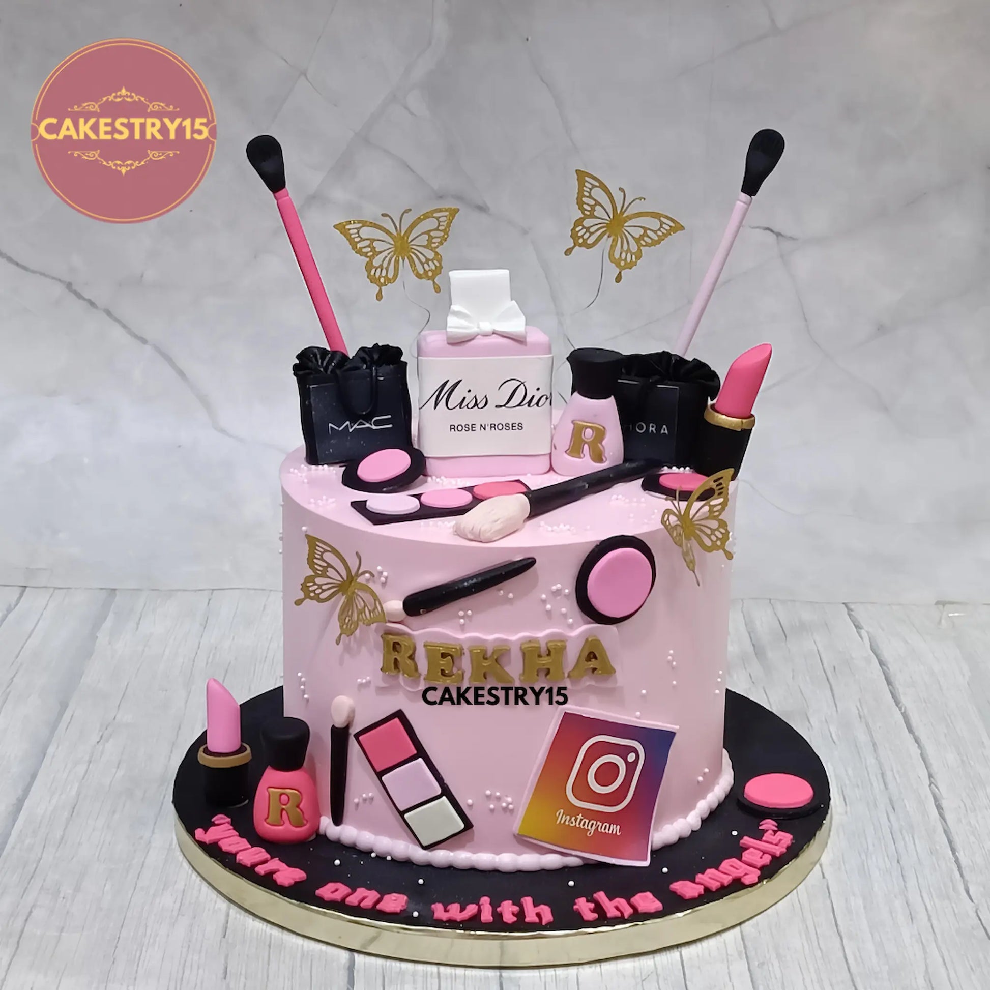 2kg eggless pineapple makeup theme cake from Cakestry15 featuring MAC and Sephora shopping bags, Miss Dior perfume, lipsticks, and golden butterflies