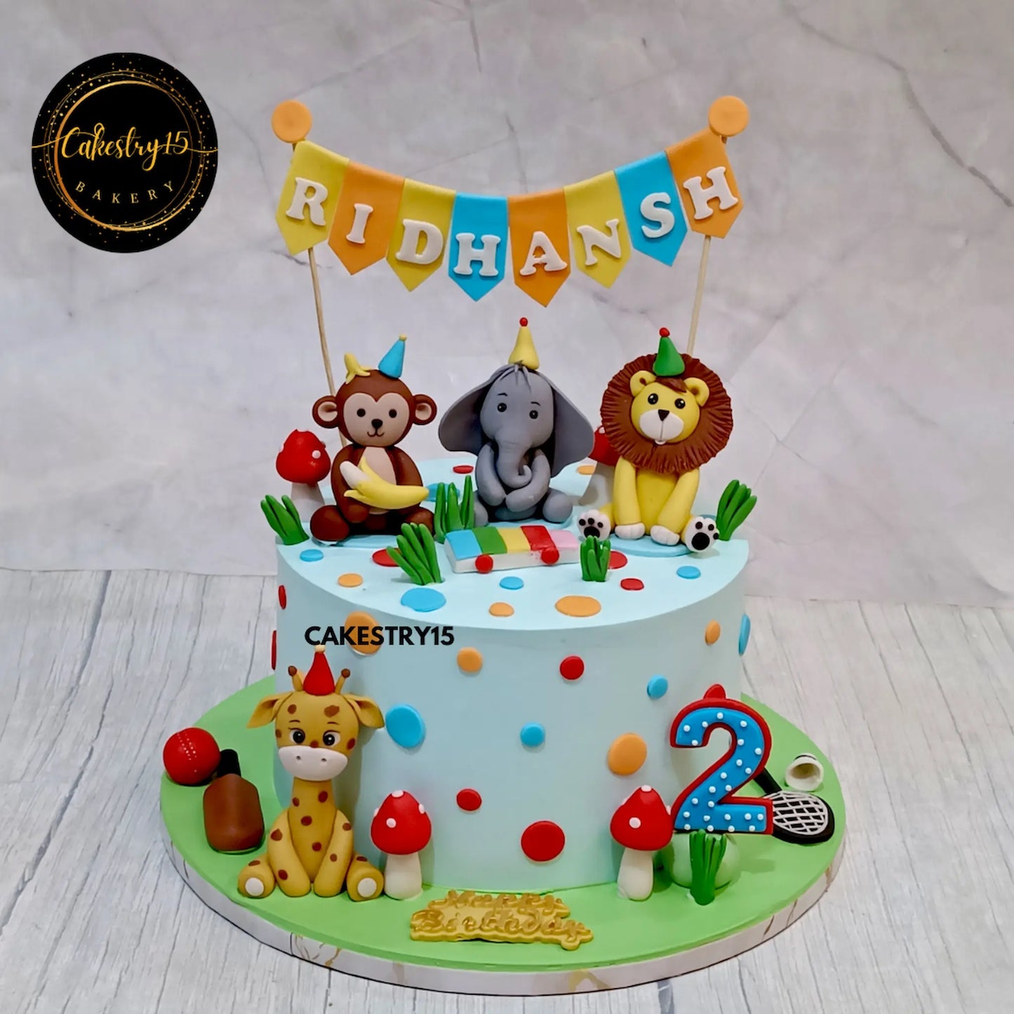 Ridhansh’s 2nd birthday jungle cake with monkey, lion, elephant, giraffe and mushrooms